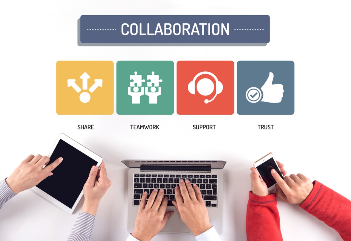 Hands using devices around a laptop, with icons representing collaboration: Share, Teamwork, Support, and Trust.