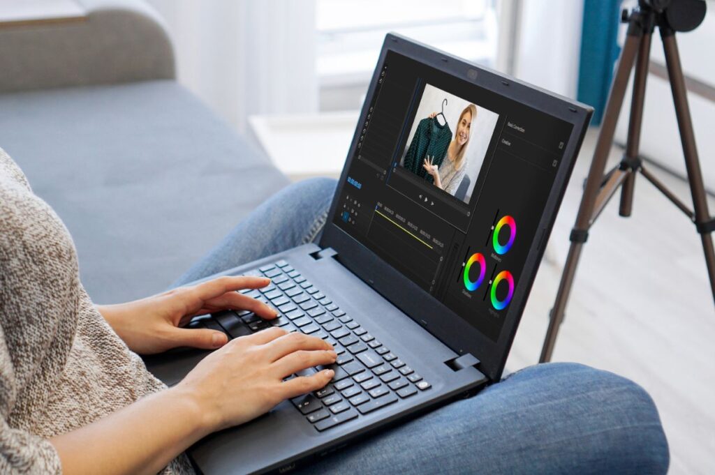 Woman editing video on laptop computer for her vlog.