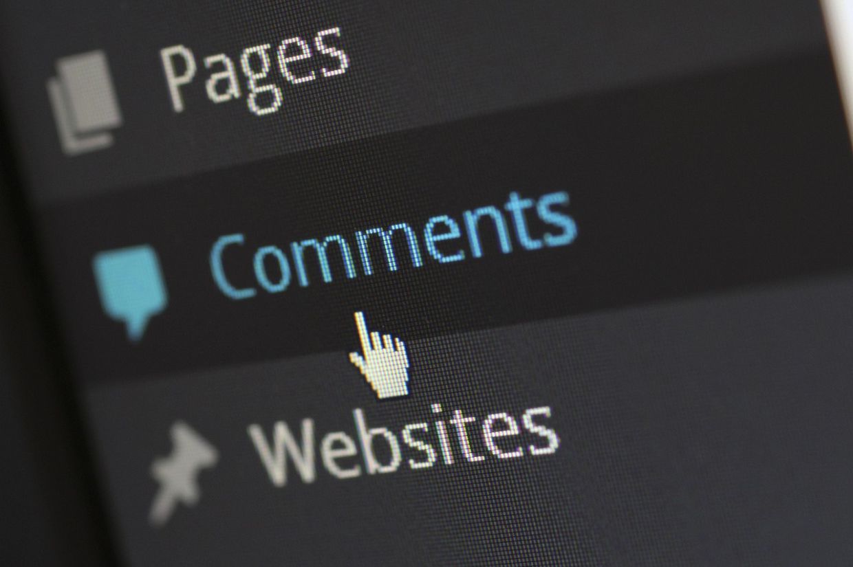 A computer screen displaying a website dashboard with a cursor hovering over the 'Comments' section — representing the potential to transform blog comments into a vibrant online community.